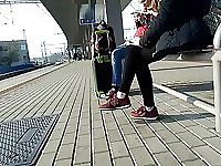 Candid girl wearing new balance sneakers waiting for a tain